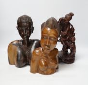 A Chinese carved rootwood figure emblematic of longevity on stand and two carved African busts,