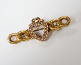 A late Victorian 15ct gold and seed pearl set bar brooch, with central heart with knot motif,
