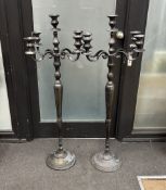 A pair of bronzed metal floor standing candelabra, height 120cm