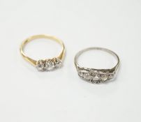 An 18ct gold three stone diamond ring, size M and a white metal five stone diamond dress ring,