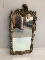 An 18th century style carved and composition wall mirror, width 43cm, height 86cm