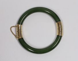 Am Eastern gilt metal mounted nephrite hinged bangle, 7.5cm