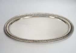 A Far Eastern white metal oval tray, with gadrooned and beaded rim, stamped silver, 45cm