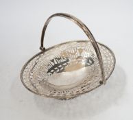 A George V pierced silver oval sweetmeat dish, with swing handle and fretwork decoration, Goldsmiths