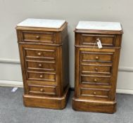 A pair of late 19th century French walnut marble topped bedside cabinets, width 44cm, depth 32cm,