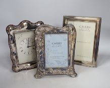 Two modern Carrs silver photograph frames, one of Art Nouveau design, 21cm, and a similar timepiece,