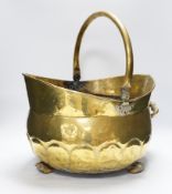 A brass helmet coal scuttle and another