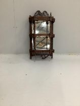 A late Victorian mahogany three tier mirrored wall bracket, width 40cm, height 76cm