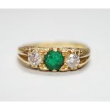 A 1970's 18ct gold emerald and diamond set three stone ring, size N/O, gross weight 4.4 grams.