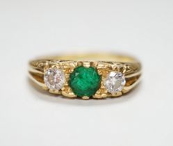 A 1970's 18ct gold emerald and diamond set three stone ring, size N/O, gross weight 4.4 grams.