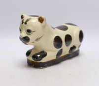 A Chinese glazed earthenware cizhou style pillow headrest in the form of a black and white cat,