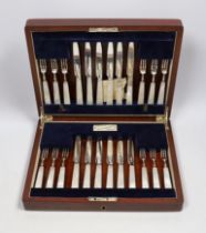 A cased set of twelve pairs of George V silver mother of pearl handled dessert knives and forks,