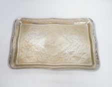 An Indian white metal dressing table tray decorated with floral motifs, 36cm