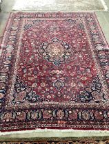A Tabriz burgundy ground floral carpet 334 x 224cm