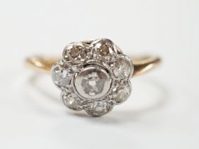 A yellow metal eight stone diamond cluster ring, size N