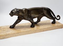 A French Art Deco bronzed metal model of a panther on a marble base, base 55cm wide