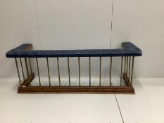 A late Victorian brass and oak club fender, with a buttoned blue leather cushioned seat, width