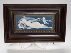 A framed Limoges pate sur pate plaque, of a reclining nude with cherubs, 31cm x 19.5cm