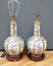 A pair of Chinese famille rose lamp bases on wooden stands, 50cm high