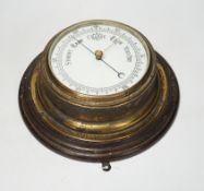 A wooden mounted wall circular aneroid barometer, 28cm diameter