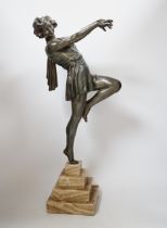 A spelter Art Deco figure of a woman, signed Carlier, on a stepped marble base, 52.5cm