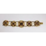 A Continental gilt metal bracelet inset with cabochon, garnets and pastes, length 15.5cm