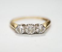 An 18ctct & plat, three stone diamond set ring, size L, gross weight 3.1 grams.