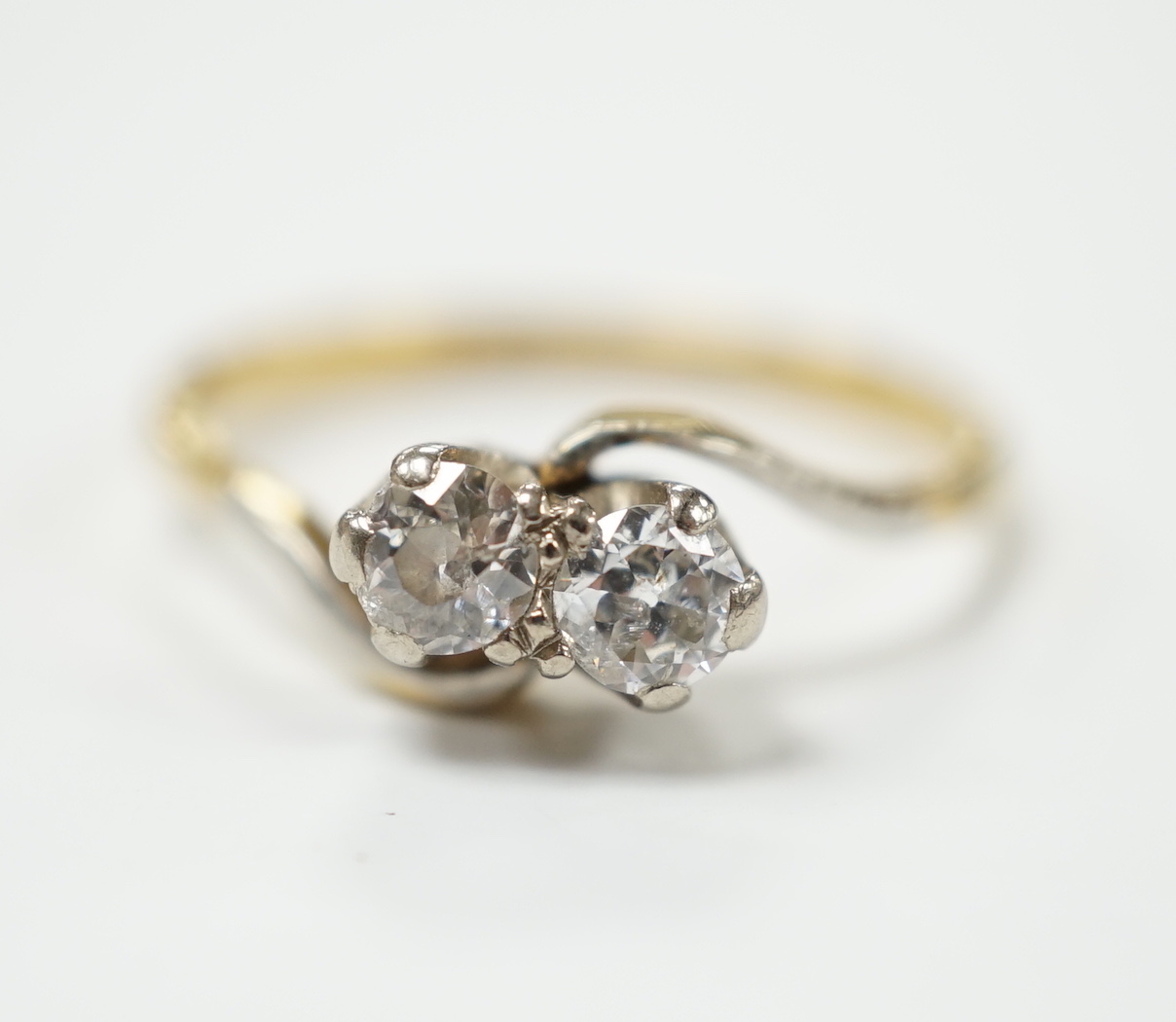 An 18ct gold and platinum two stone diamond ring, size M