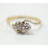 An 18ct gold and platinum two stone diamond ring, size M