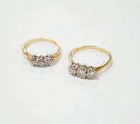 An 18ct gold three stone diamond ring, size M, and a similar ring of larger size, size P, gross 6.