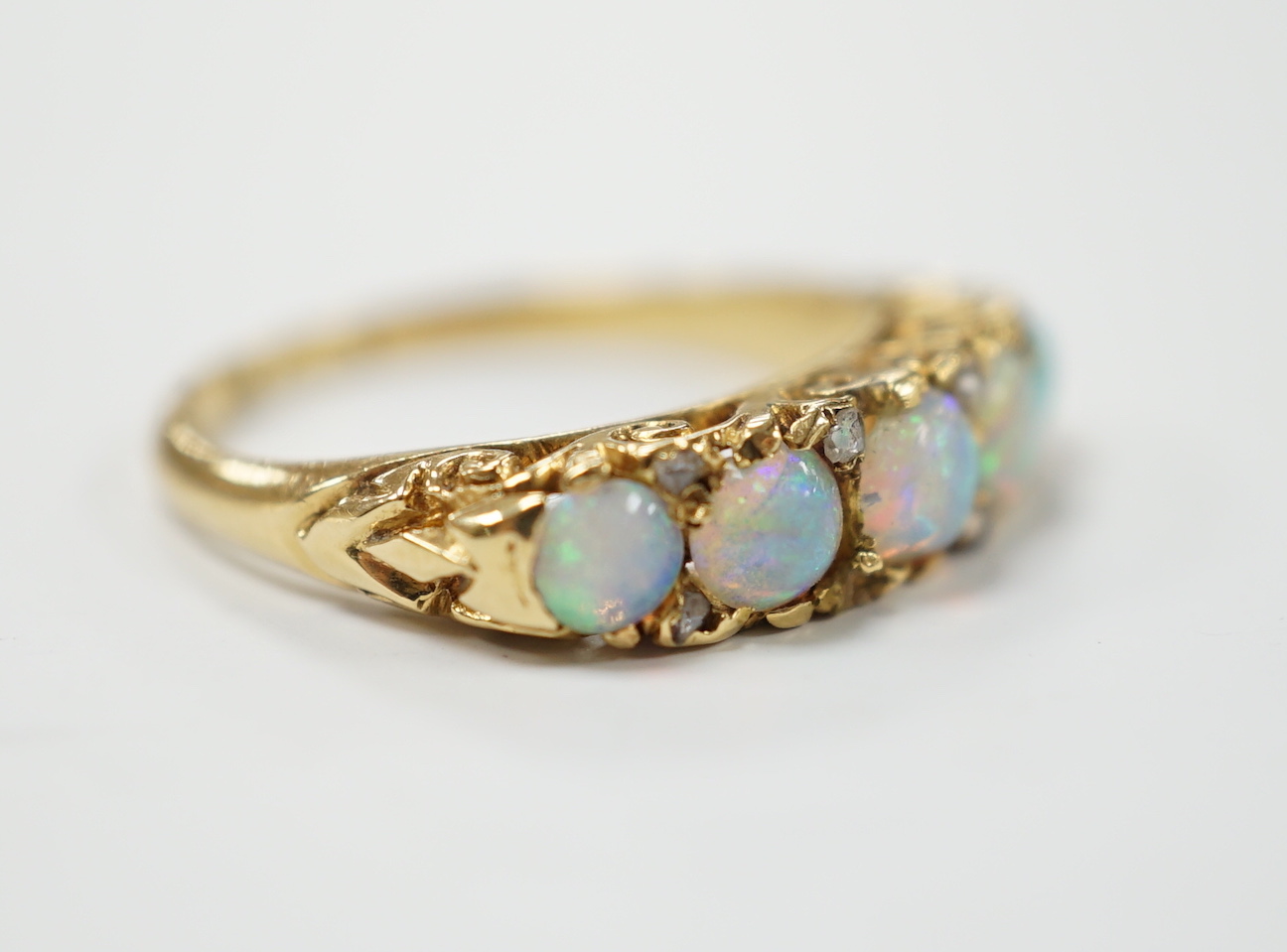 A late Victorian yellow metal and white opal five stone ring with diamond chip set spacers, size M - Image 3 of 4