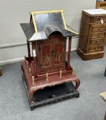 A Chinese scarlet and black lacquer temple shrine, height 112cm