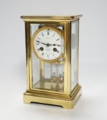 An early 20th century brass four glass clock retailed by Dent, 22cm