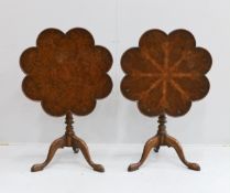 A pair of reproduction George III style mahogany and bird's eye maple tilt top tripod tea tables,