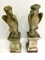 A pair of reconstituted stone models of eagles, on square plinths, height 125cm (eagle head