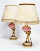 A pair of early 20th century French ormolu and porcelain cherubic lamps, one signed L. Kley, 48cm