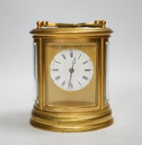 A French hour repeating oval carriage clock, striking on a coiled gong, 13cm