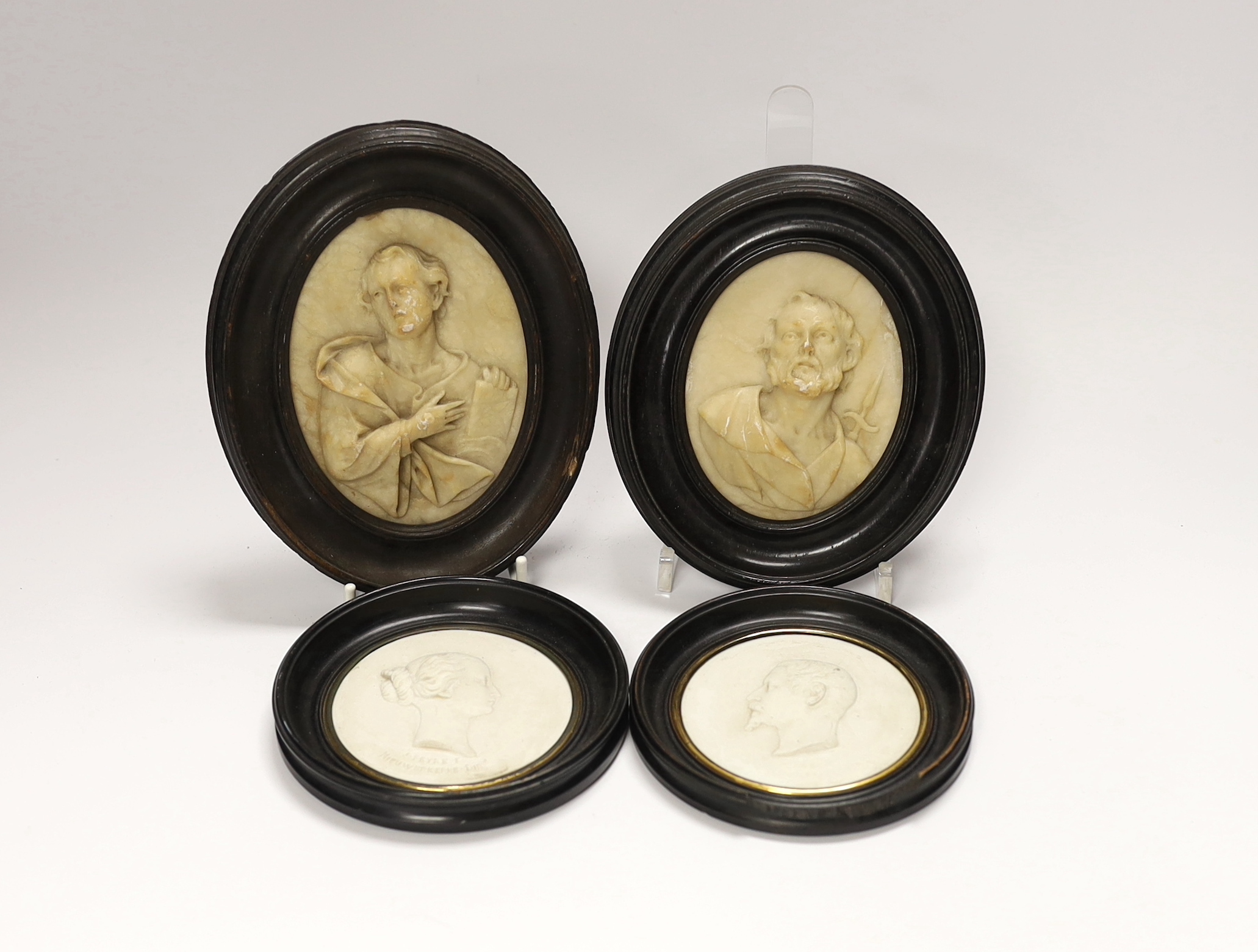 A pair of 19th century alabaster relief carved religious plaques and a pair of Sevres biscuit
