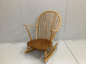 An Ercol elm and beech comb back rocking armchair, width 73cm, depth 78cm, height 95cm