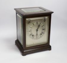 A mahogany striking mantel clock with silvered dial and German movement, 26cm high