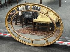 An oval giltwood and composition marginal plate wall mirror, width 113cm, height 83cm