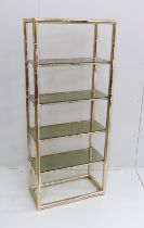 A Maison Jansen style faux bamboo brass and smoked glass five tier shelf unit, width 76cm, depth