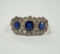 A yellow metal and millegrain set sapphire and diamond triple cluster ring, size K/L, gross weight