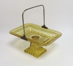 An American amber pressed glass comport/basket with swing handle, probably Pittsburg, 27cm wide