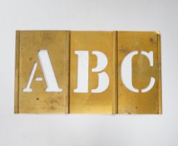A cased brass stencil alphabet