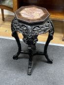 A Chinese octagonal marble topped hardwood jardiniere stand, width 38cm, height 61cm
