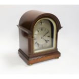 A mahogany mantel clock with silvered Roman numeral dial, 23cm high