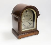A mahogany mantel clock with silvered Roman numeral dial, 23cm high