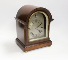 A mahogany mantel clock with silvered Roman numeral dial, 23cm high