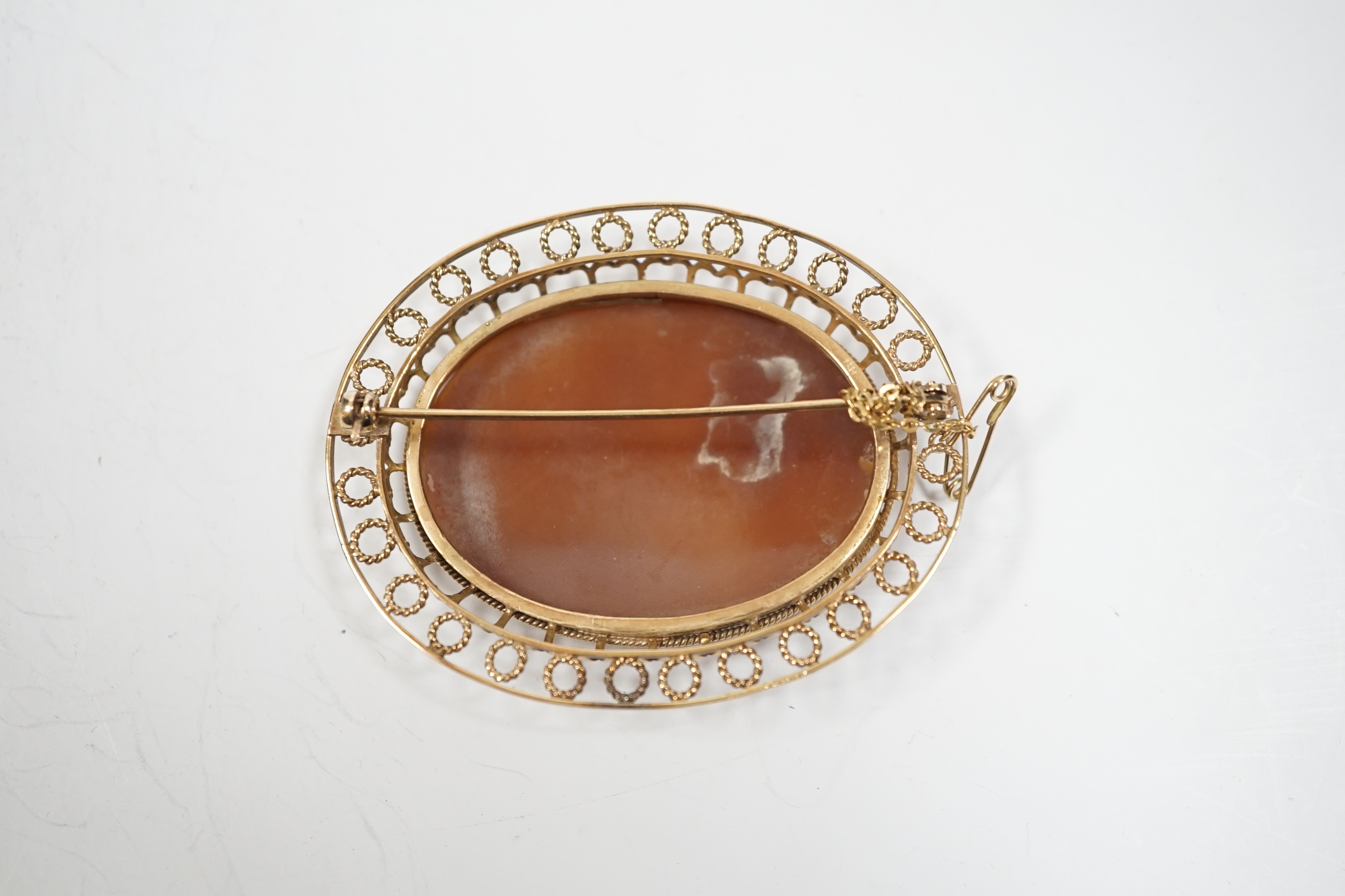 A yellow metal mounted oval cameo shell brooch, carved with two seated ladies with sheep, beneath - Image 2 of 2